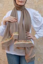 A coffe soft cotton scarf with a colorful trim.
