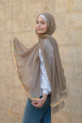 A coffe soft cotton scarf with a colorful trim.