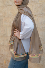 A coffe soft cotton scarf with a colorful trim.