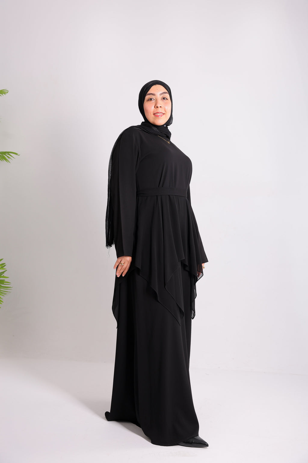 Lily crepe abaya is designed with delicate chiffon ruffles and a matching belt code 112 B