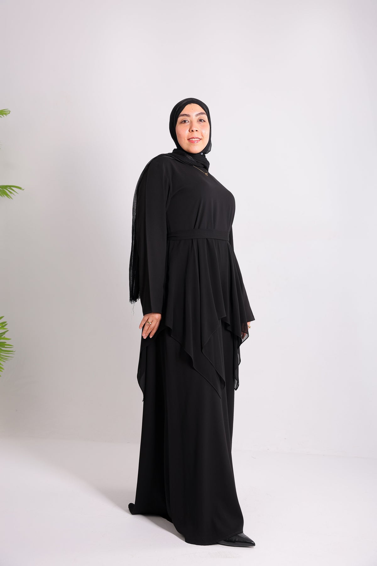 Lily crepe abaya is designed with delicate chiffon ruffles and a matching belt code 112 B