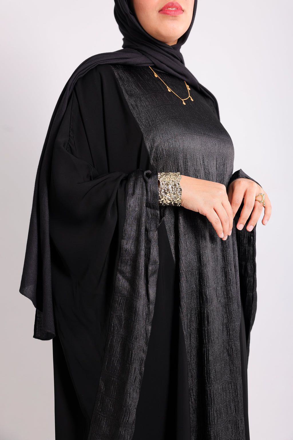 A luxurious silk abaya with embroidered silk accents, designed with an inner belt Code 405